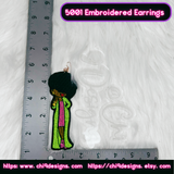 Afro Diva embroidered earring with a ruler for scale, emphasizing the size and vibrant design.