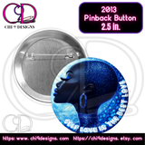 A 2.5-inch pinback button featuring an artistic design of a Black woman in radiant blue tones with sparkles, paired with the phrase "Self Love is the Best Love" in white text.