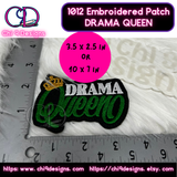 Green and white Drama Queen embroidered patch next to a ruler for size reference.