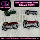 Four Drama Queen embroidered patches in different color options on a white fur background.