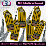 A set of embroidered pencil bookmarks, each featuring a detailed yellow pencil design with a silver tassel, displayed in an overlapping pattern on a white wooden background.