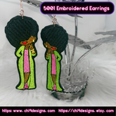 Pair of Afro Diva embroidered earrings in green and pink, hanging on a decorative stand.