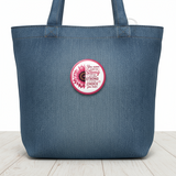 Pinback button with pink sunflower and motivational quote on a white background