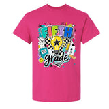 A bright pink short-sleeve t-shirt with a colorful 'Fifth Grade' graphic on the front, featuring a lightbulb, stars, pencils, and school supplies, shown against a plain white background.