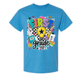 A heather blue short-sleeve t-shirt with a colorful 'FIRST grade' graphic on the front, featuring a lightbulb, pencil, notebook, and stars.