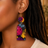 Beautiful woman wearing Blue Floral Wood Dangle Earrings by Chi 9 Designs.