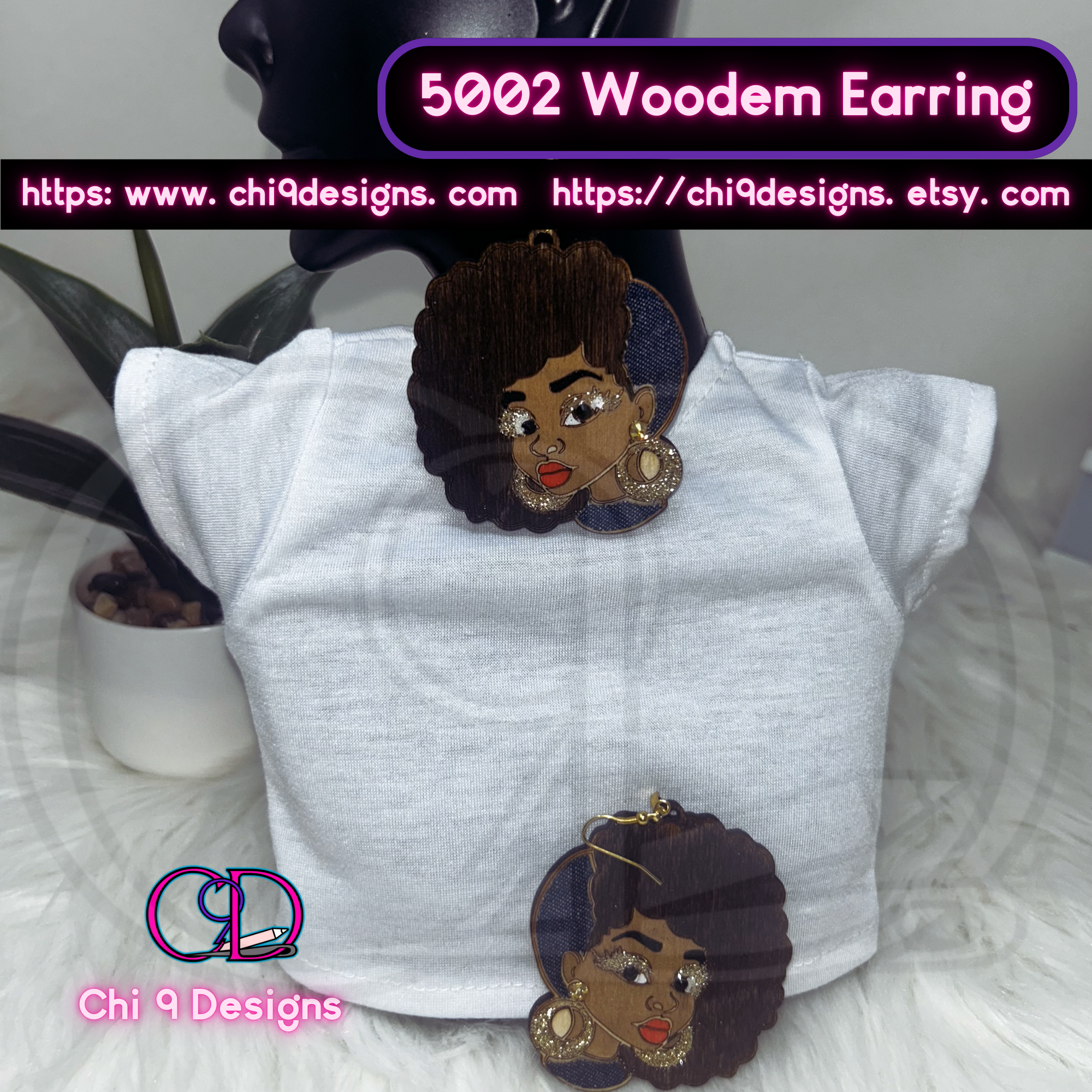 A pair of Afrocentric wooden earrings featuring a bold woman's face with an Afro hairstyle, accented with fabric inlay, glitter, and decorative stones, displayed on a mannequin wearing a white top.
