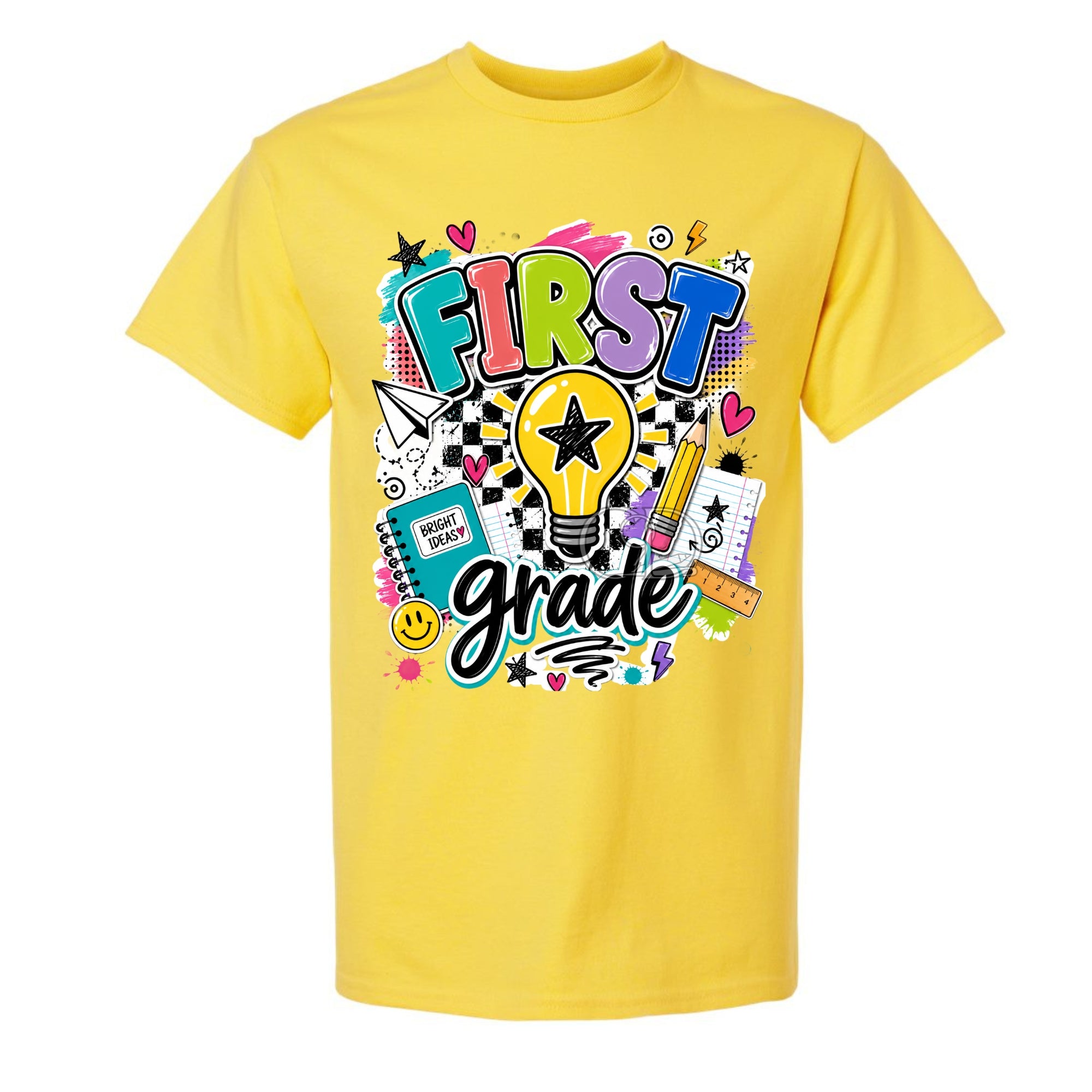 A bright yellow short-sleeve t-shirt with a colorful 'FIRST grade' graphic on the front, featuring school-themed doodles and text, shown against a plain white background.