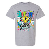 A heather gray short-sleeve crewneck t-shirt featuring a colorful 'FIFTH grade' graphic on the chest with a lightbulb, stars, hearts, and school-themed doodles.