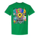 A green short-sleeve crewneck t-shirt featuring a colorful 'SECOND grade' graphic on the front, complete with a lightbulb, checkered pattern, and school-themed doodles, shown against a plain white background.