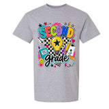 A heather gray short-sleeve crewneck t-shirt featuring a colorful graphic print on the front with the words 'SECOND grade' in playful multicolor lettering, surrounded by school-themed doodles like a lightbulb, notebook, pencil, and stars.