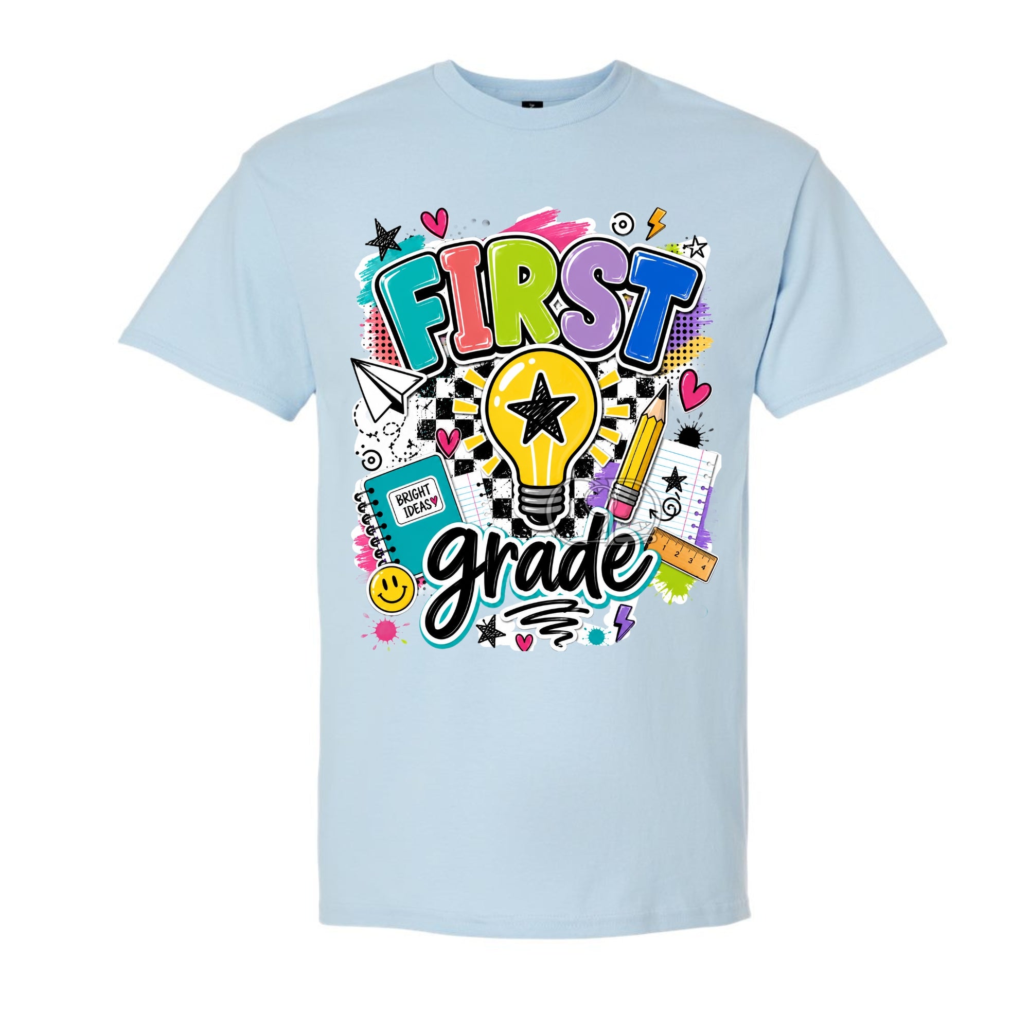 A light blue crewneck t-shirt featuring a colorful 'FIRST grade' graphic on the front, complete with a lightbulb, stars, hearts, and school supplies, shown against a plain white background.