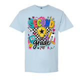 A light blue short-sleeve crewneck t-shirt featuring a colorful 'Second Grade' school-themed graphic on the front, displayed against a solid white background.