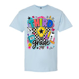 A light blue short-sleeve crewneck t-shirt featuring a colorful 'Third Grade' graphic on the front, complete with a lightbulb, stars, hearts, and school supplies.