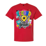 A red short-sleeve crewneck t-shirt featuring a colorful graphic on the front that reads 'SECOND grade' with school-themed doodles including a lightbulb, notebook, pencil, and stars.