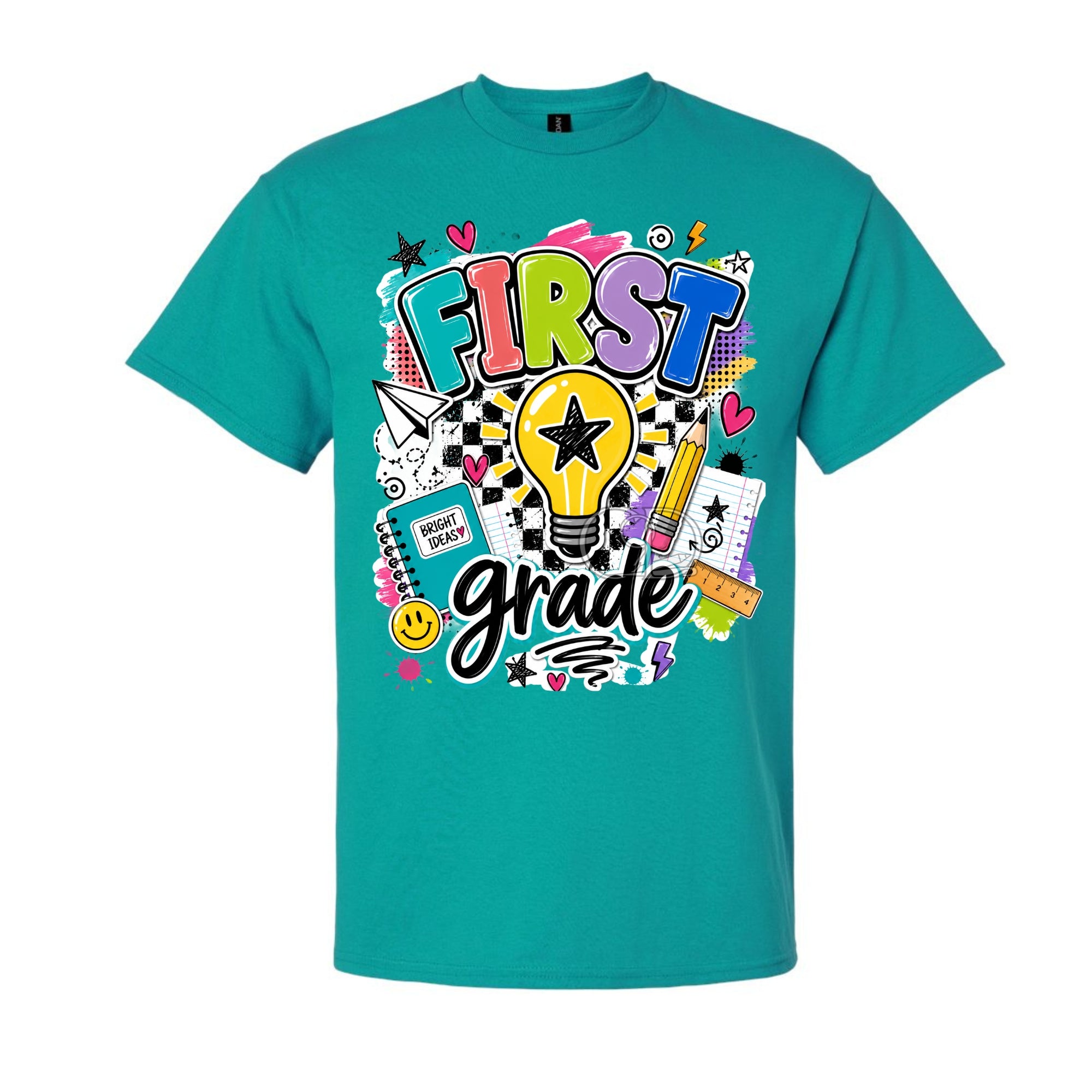 A teal short-sleeve crewneck t-shirt featuring a colorful 'FIRST grade' graphic on the front, complete with a lightbulb, pencil, notebook, and stars.