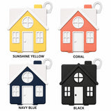 Four house-shaped product options arranged in a 2x2 grid on a white background, labeled Sunshine Yellow, Coral, Navy Blue, and Black. Each house has a white roof, door, and window trim, with different body colors shown.