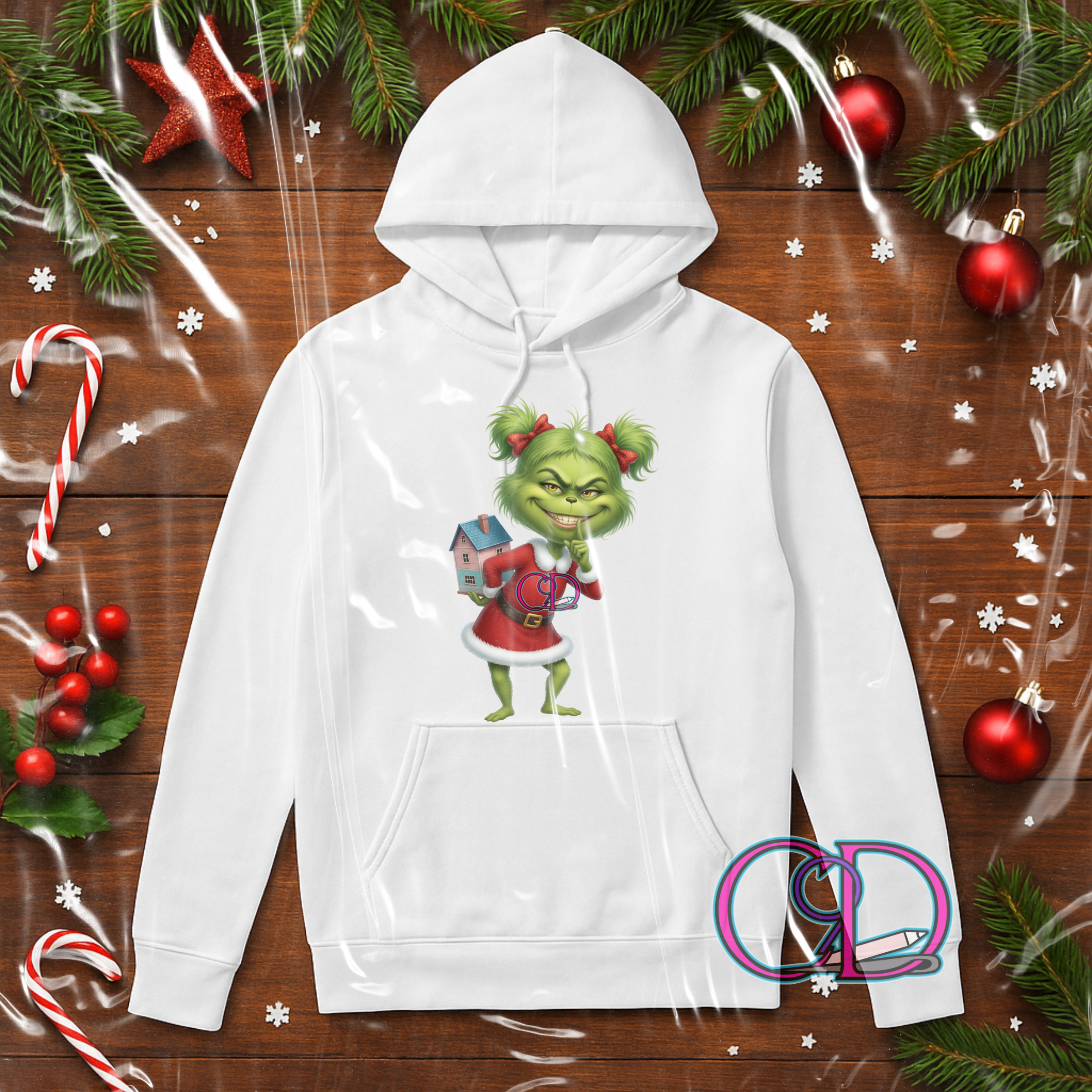 White hoodie with a Green X Mas girl design on a wooden background with Christmas decorations