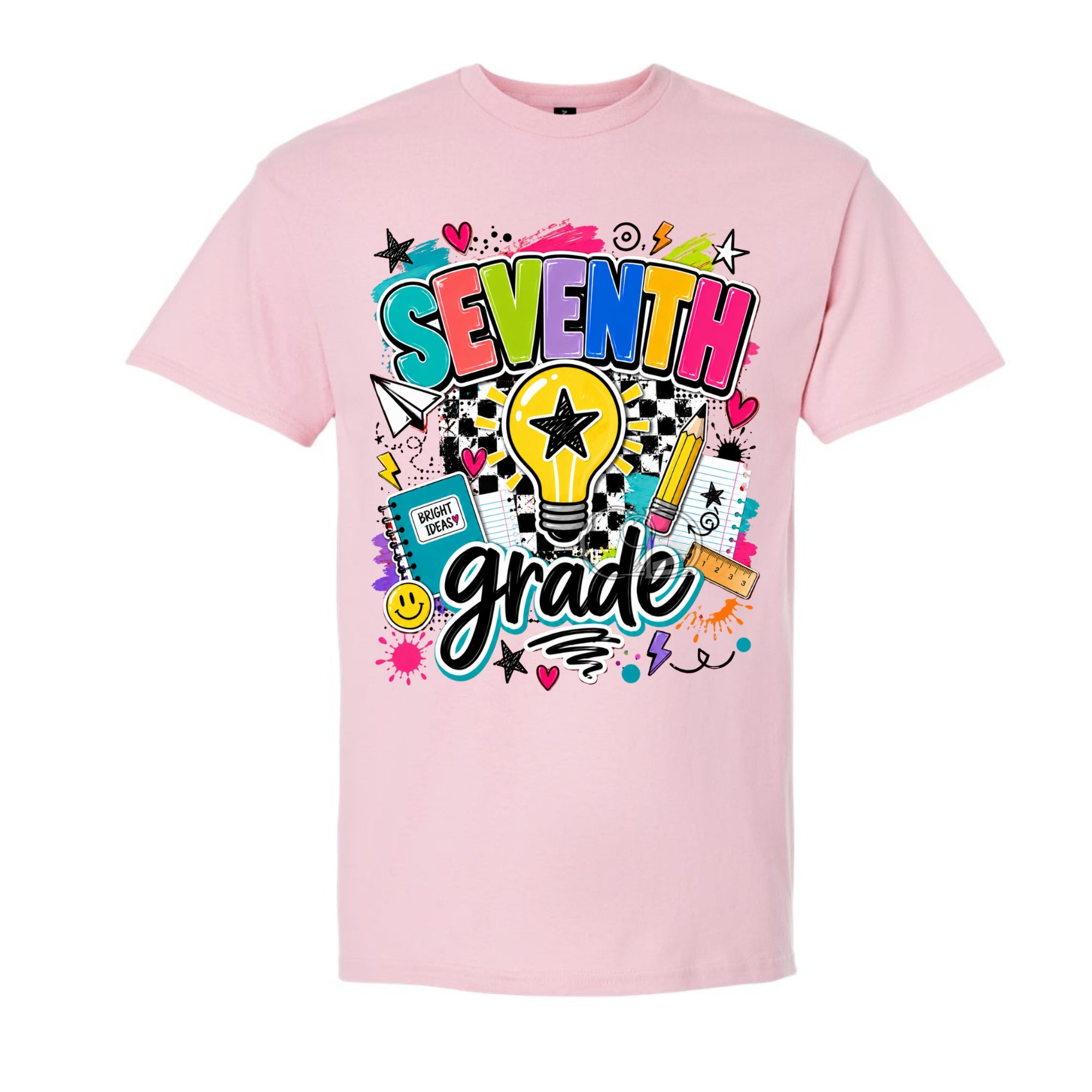 A light pink short-sleeve t-shirt with a colorful 'SEVENTH grade' graphic on the front, featuring a light bulb, stars, hearts, and school-themed doodles, shown against a plain white background.