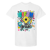 A white short-sleeve crewneck t-shirt featuring a colorful graphic print on the front with the words 'FIFTH grade' in playful multicolor lettering, surrounded by school-themed doodles like a lightbulb, pencil, notebook, and stars.
