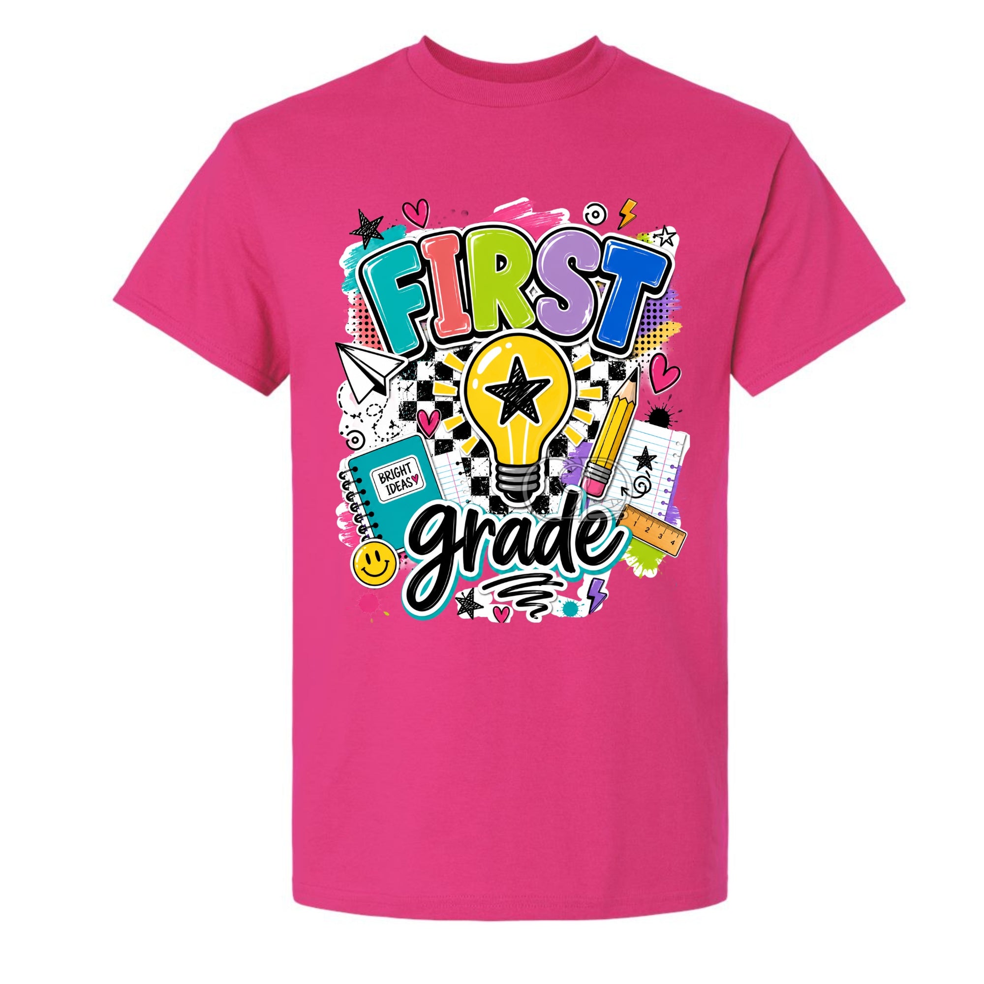 A bright pink short-sleeve crewneck t-shirt featuring a colorful 'FIRST grade' graphic on the front, complete with a lightbulb, stars, hearts, and school-themed doodles, shown against a plain white background.