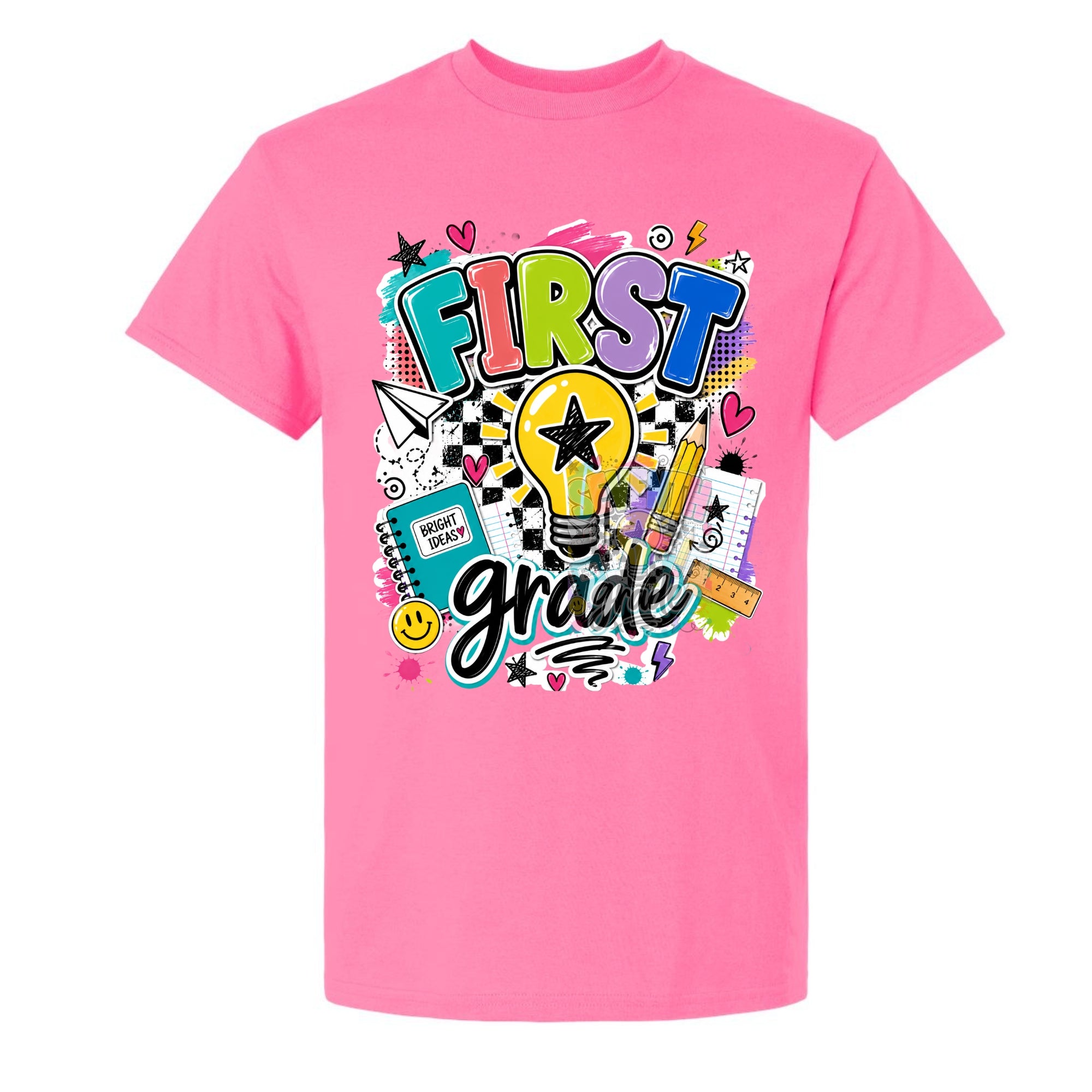 A bright pink short-sleeve t-shirt with a colorful graphic on the front that reads 'FIRST grade' surrounded by school-themed doodles like a lightbulb, notebook, pencil, and stars, shown on a plain white background.