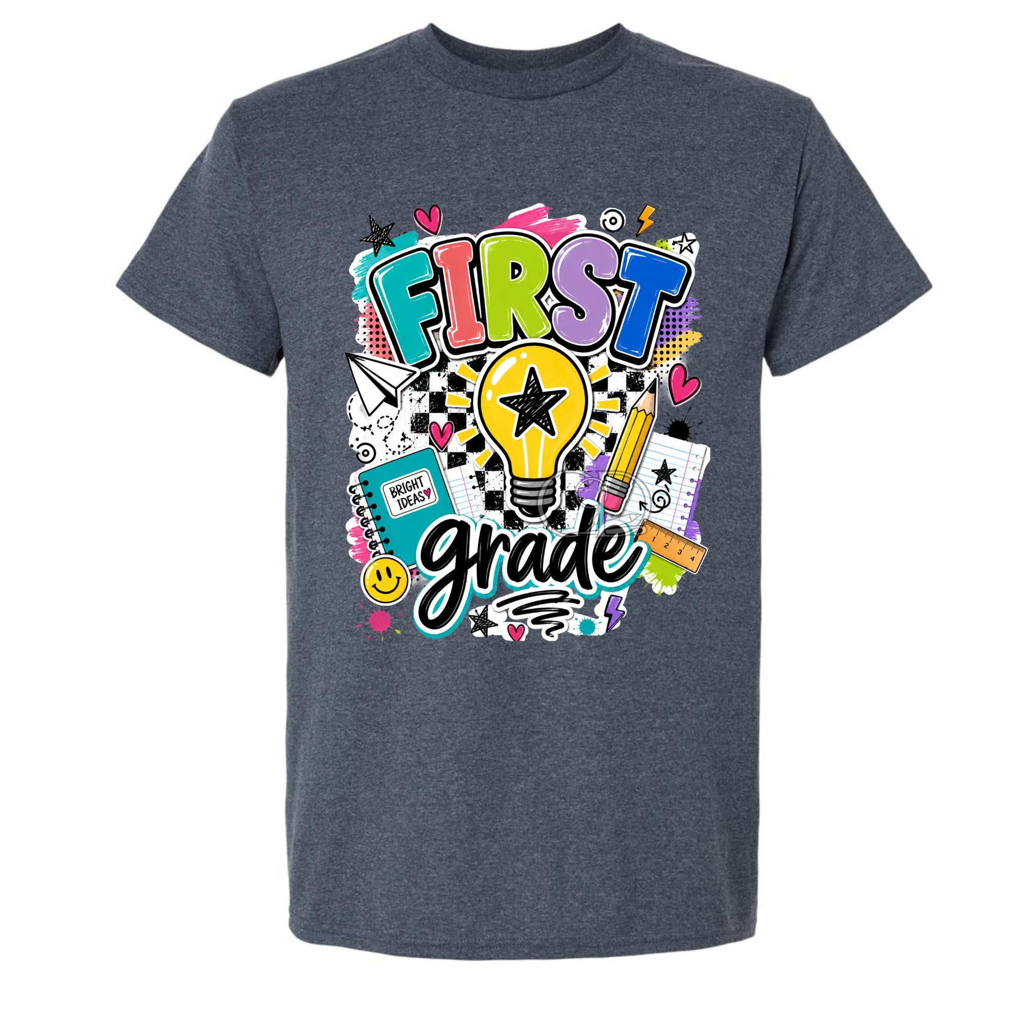 A dark heather gray t-shirt featuring a colorful 'First Grade' graphic print on the front, displayed against a solid white background.