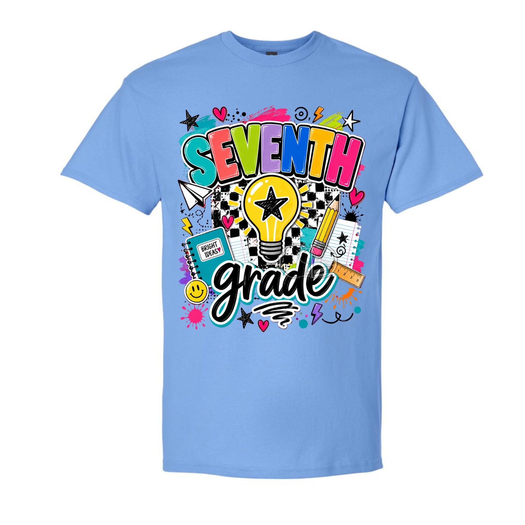 A light blue short-sleeve crewneck t-shirt featuring a colorful 'SEVENTH grade' graphic on the chest, complete with a lightbulb, stars, hearts, and school supplies, shown against a plain white background.