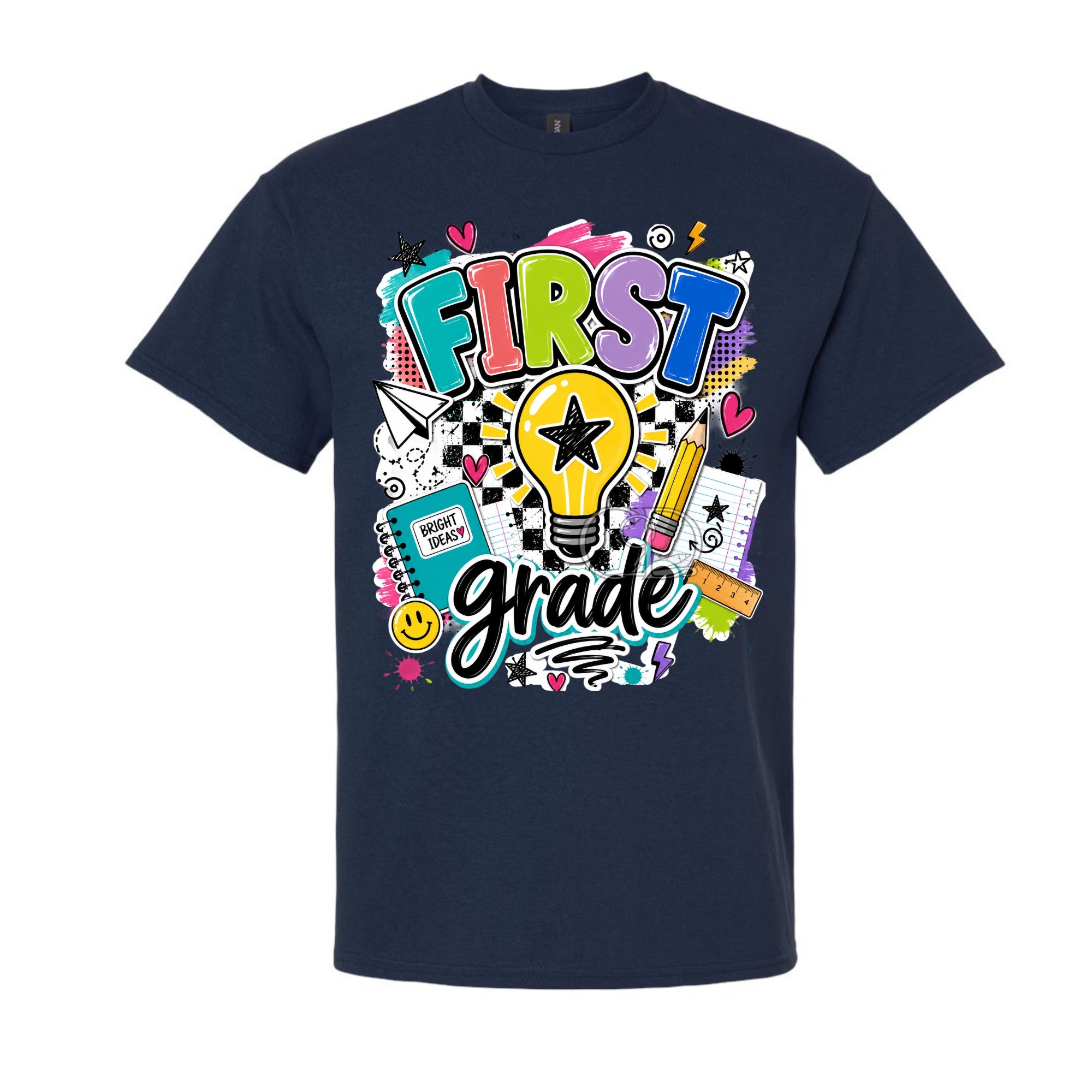 A navy blue short-sleeve crewneck t-shirt featuring a colorful 'First Grade' graphic on the front, complete with a lightbulb, pencil, notebook, and checkered pattern, shown against a plain white background.