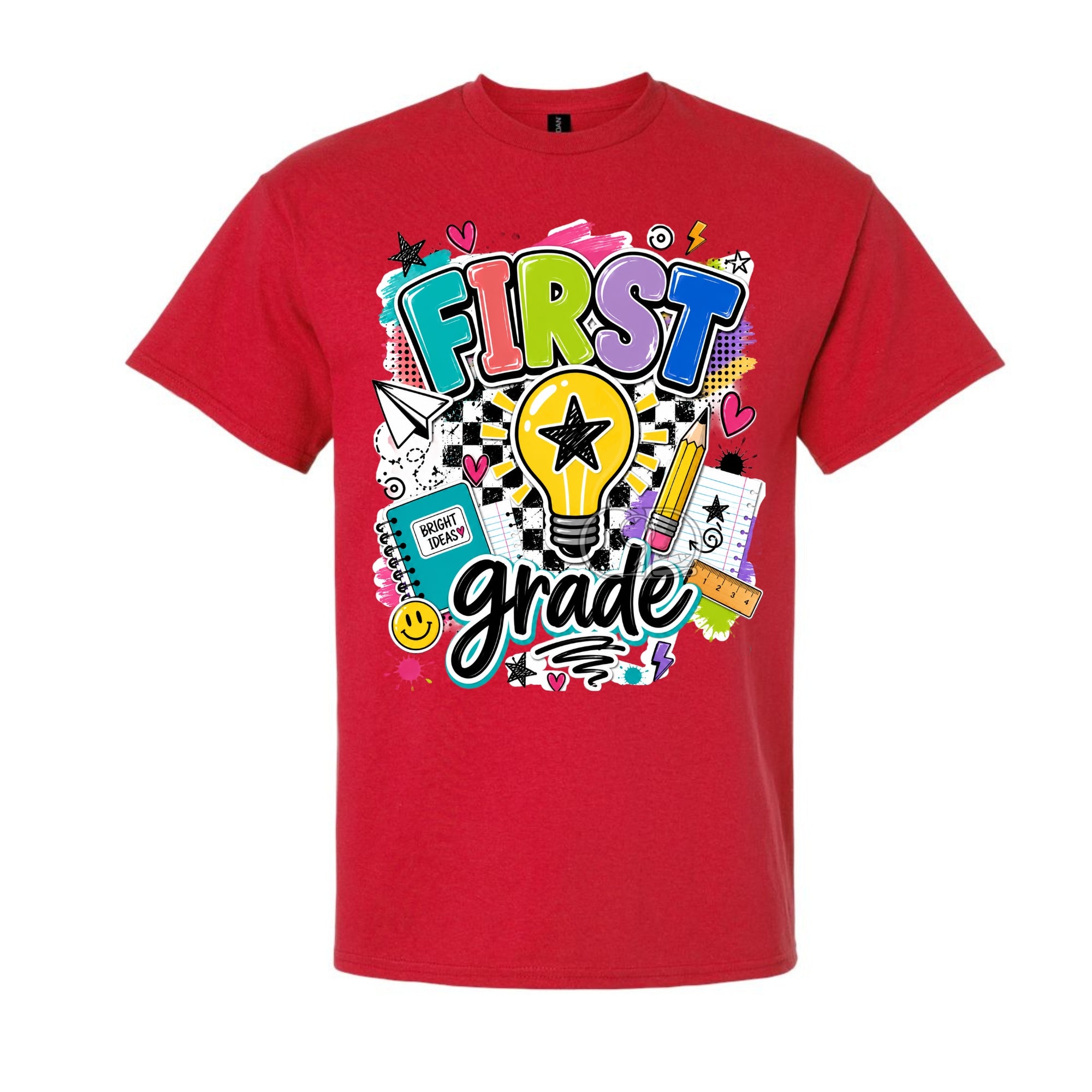 A red short-sleeve crewneck t-shirt featuring a colorful 'FIRST grade' graphic on the front, complete with a lightbulb, pencil, notebook, and checkered pattern, shown against a plain white background.