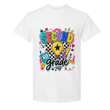 A white short-sleeve crewneck t-shirt featuring a colorful graphic print on the front that reads 'SECOND Grade' in playful multicolor lettering with school-themed doodles like a lightbulb, notebook, and pencil.